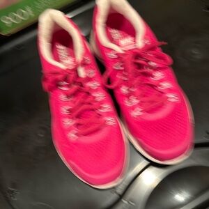 Bright pink Nike tennis shoes